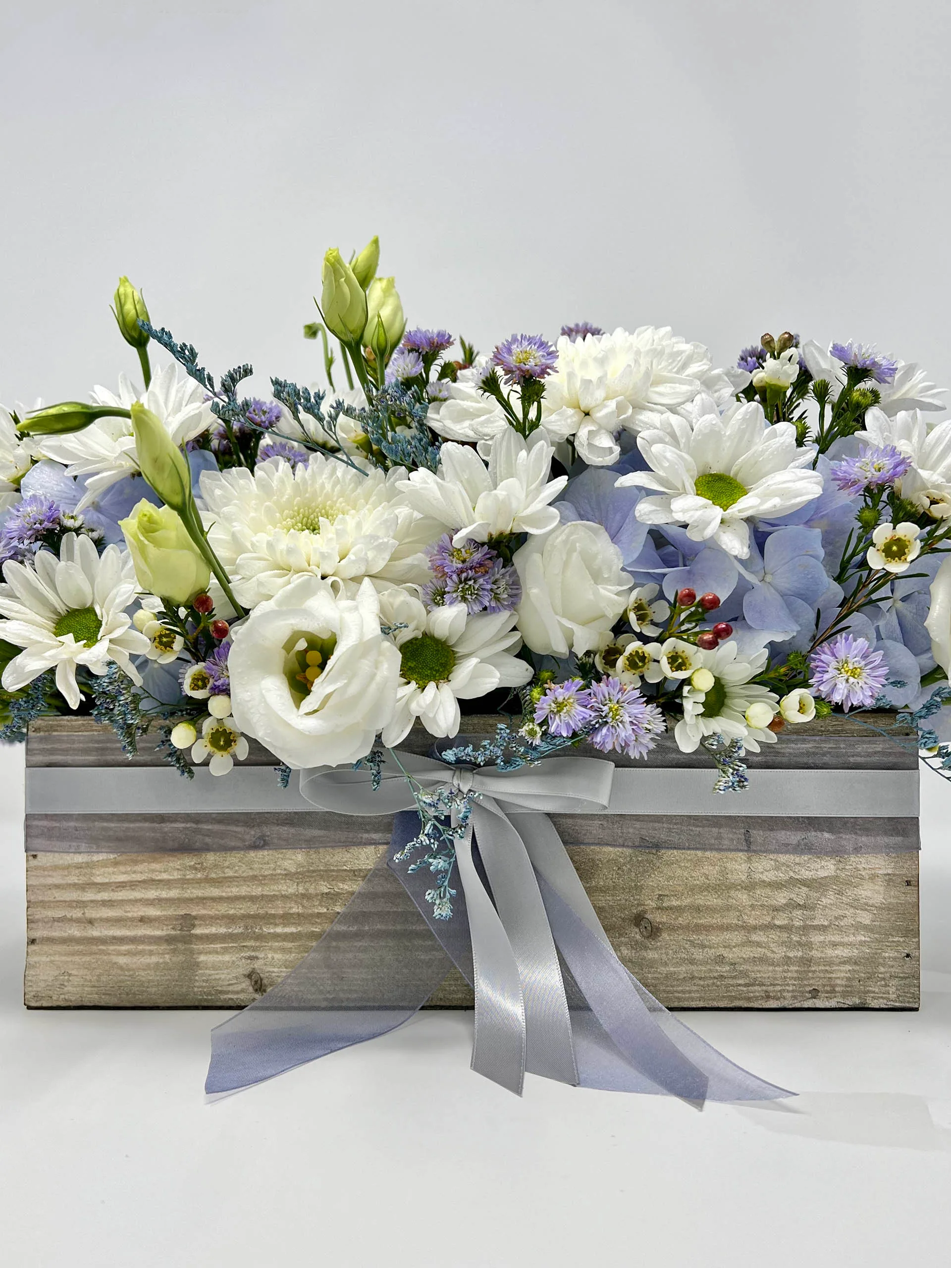 Centerpiece floral arrangement with blue and white flowers in a wooden box – Vancouver flower shop