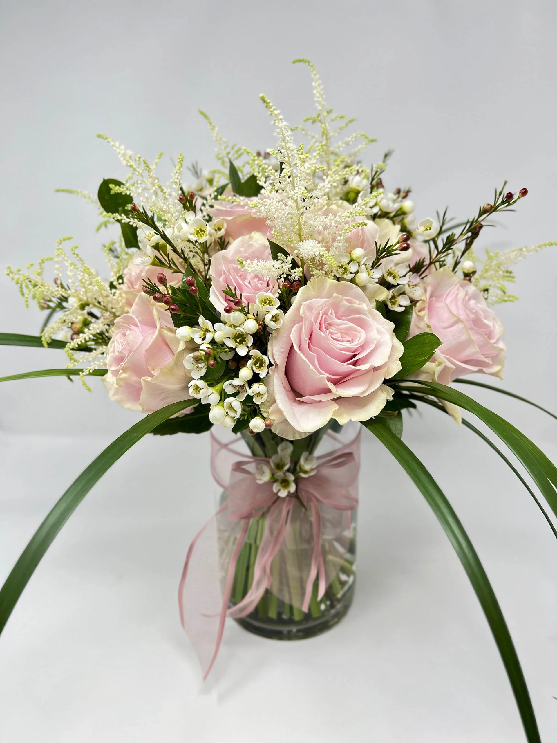 Blush Elegance Vase Arrangement with light pink roses and white astilbe in a glass vase