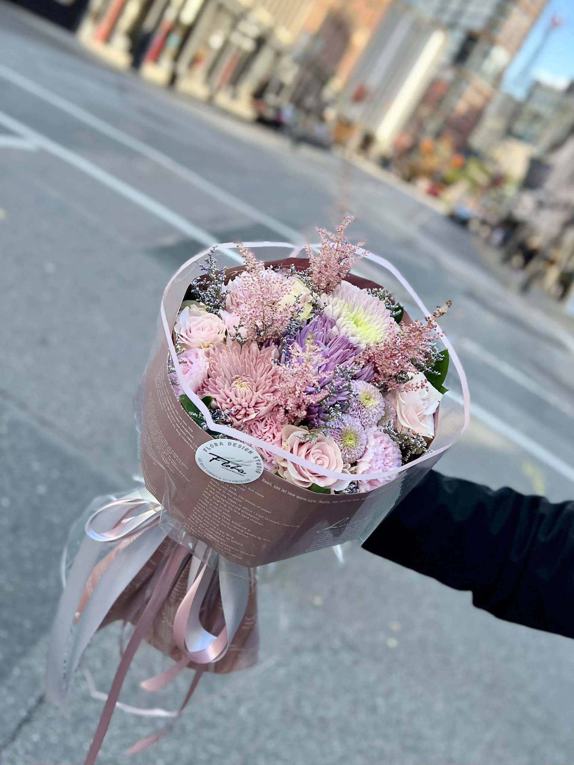 pastel bouquet with soft pink, lavender, and cream flowers wrapped in elegant paper – Floba Vancouver