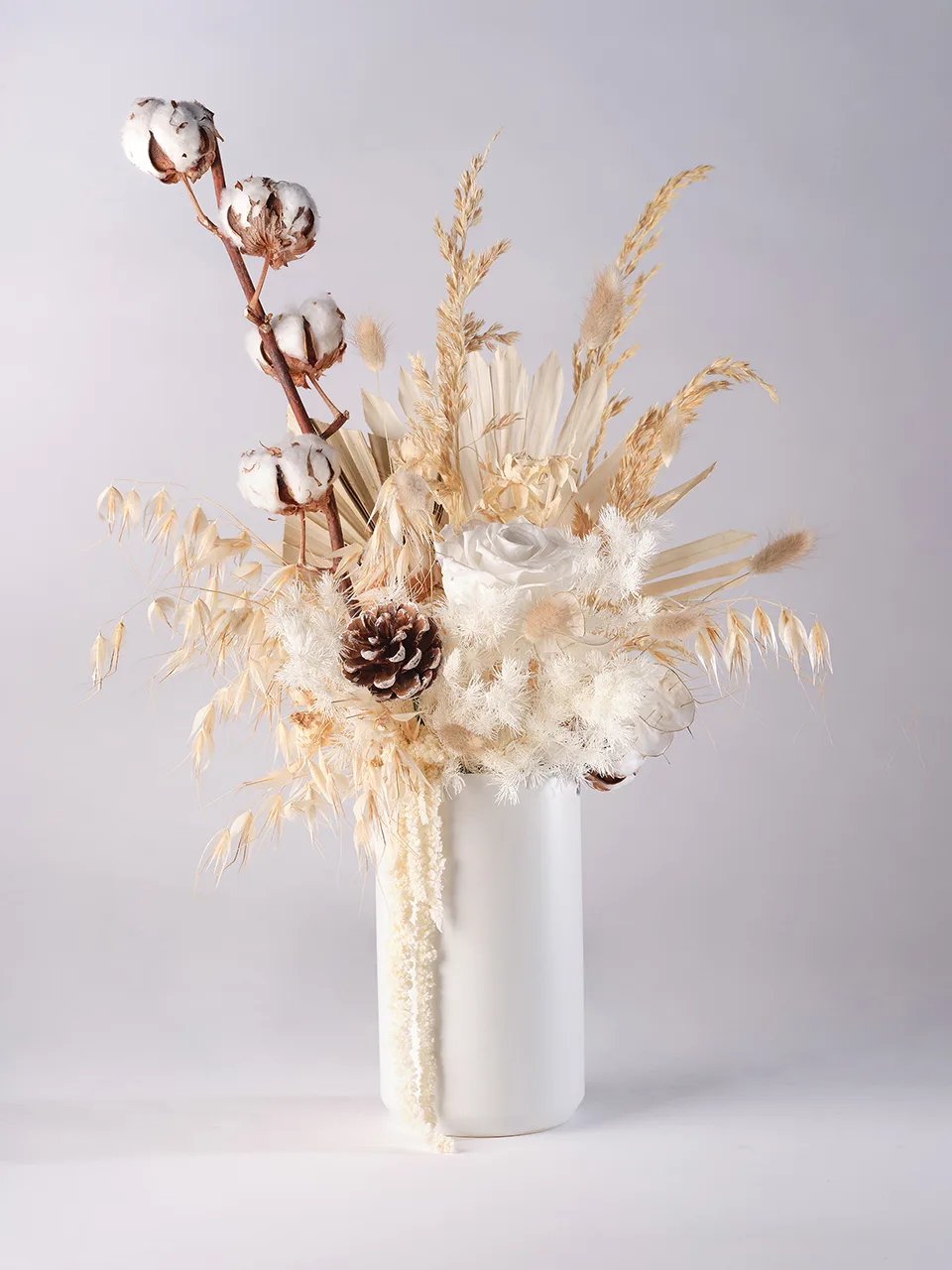 Ivory dried flower arrangement – preserved cotton, roses, and pinecone in white ceramic vase