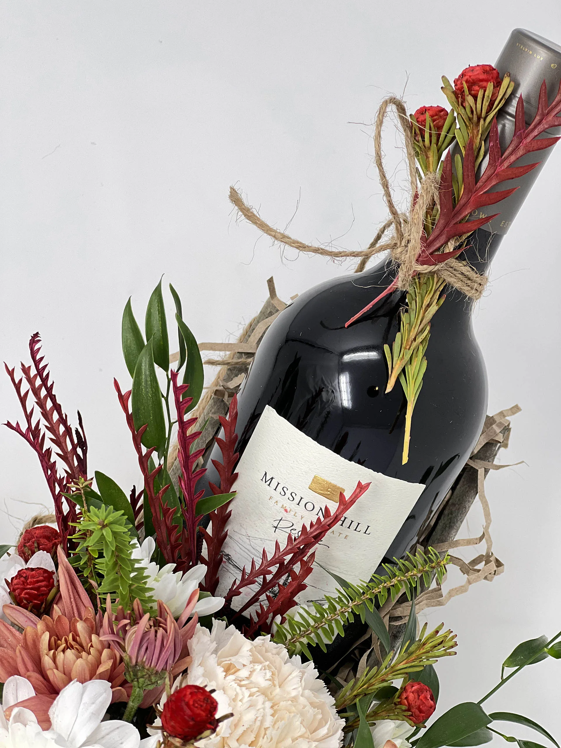 Rustic floral gift box with white chrysanthemums, carnations, and wine bottle space