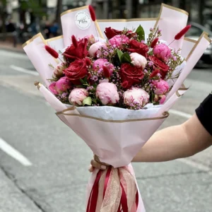 Hand-holding a luxury peony and rose bouquet on Vancouver’s Gastown street