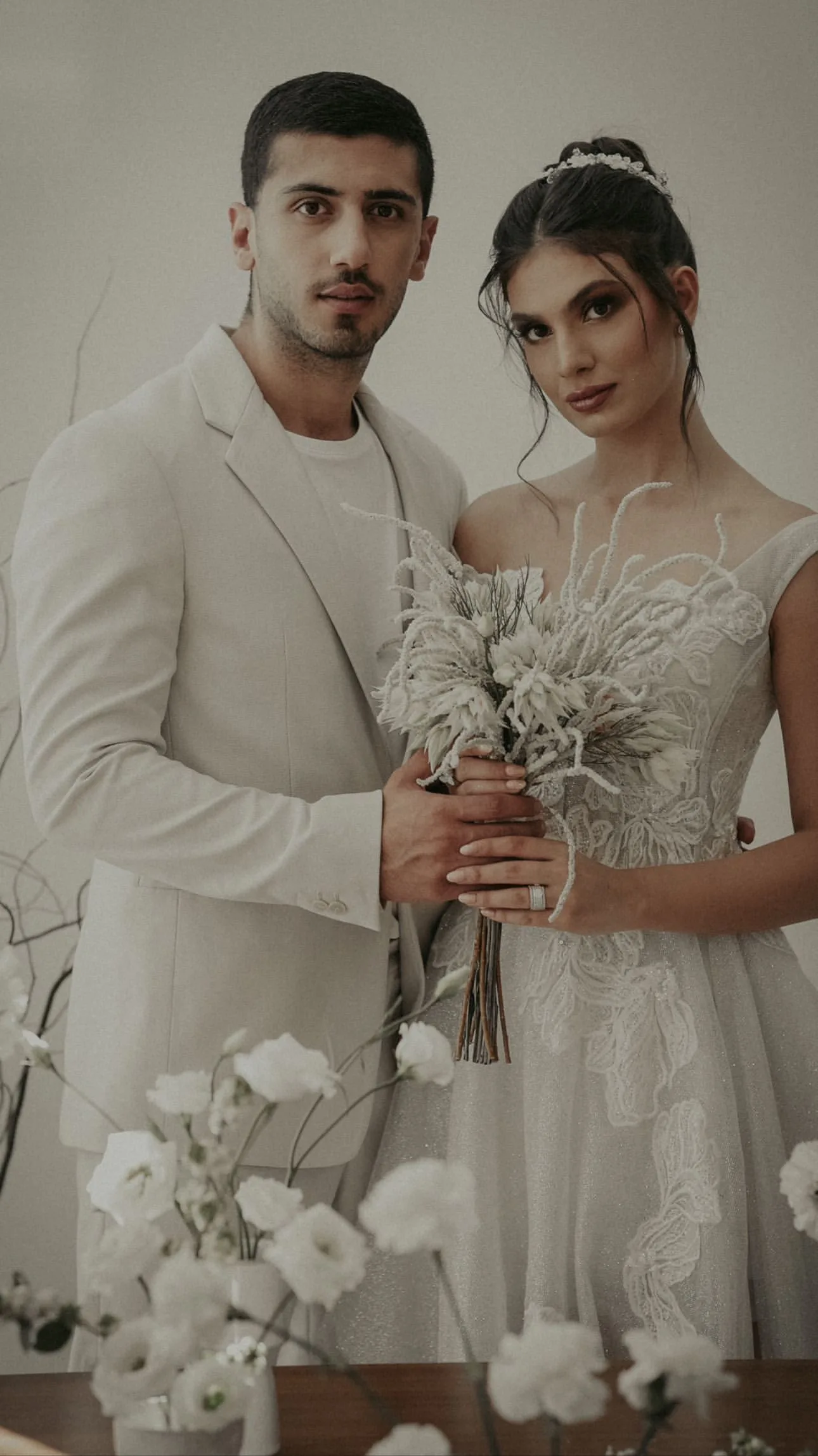 Bride and Groom with Minimalist White Bouquet – Floba Flower Boutique Elegant bride and groom holding a delicate white floral bouquet, styled for a modern minimalist wedding by Floba Flower Boutique in Vancouver.