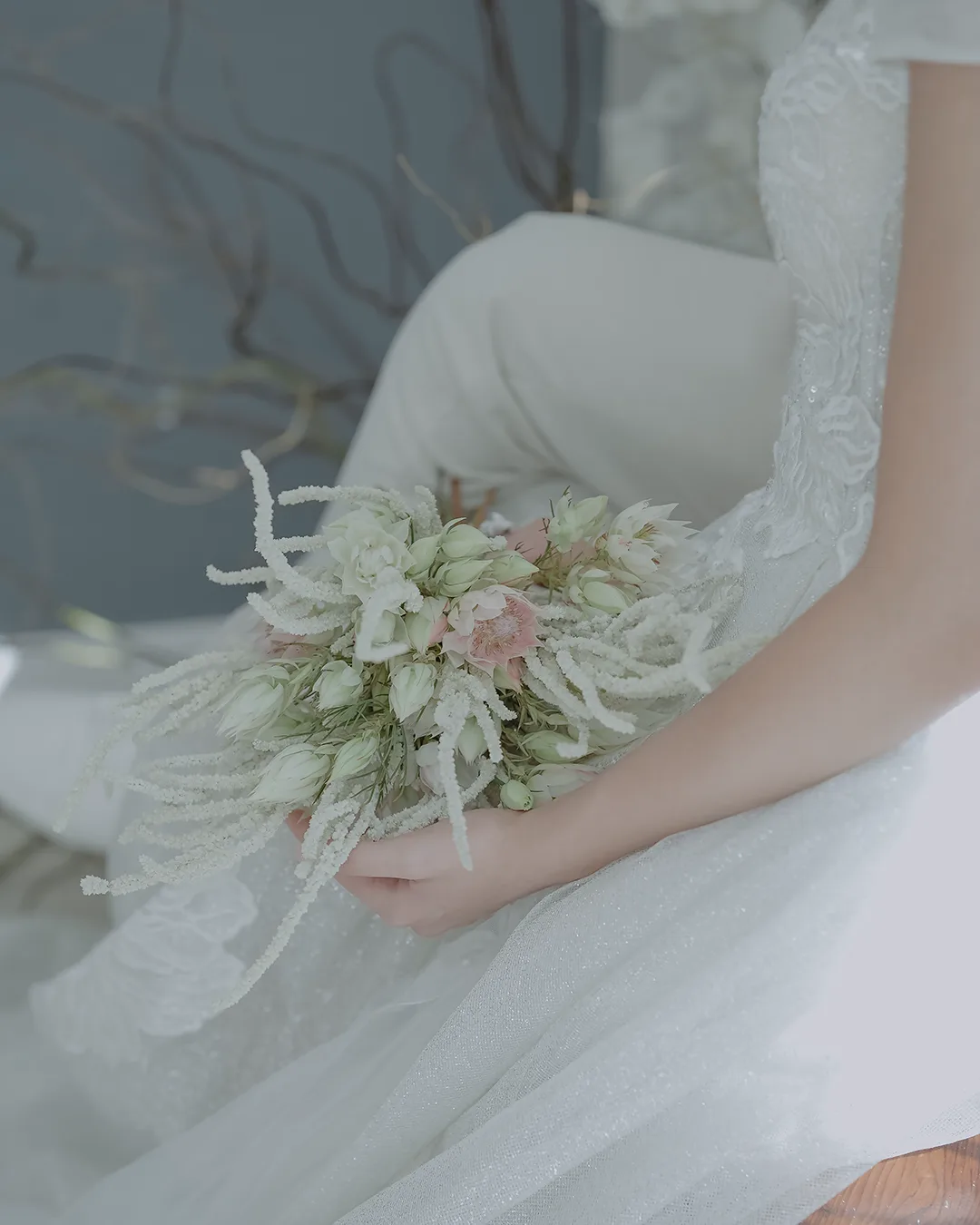 Delicate White and Blush Bridal Bouquet – Floba Flower Boutique Close-up of a bride holding a delicate bouquet of white and blush flowers with soft textures, styled for a minimalist wedding by Floba Flower Boutique in Vancouver.