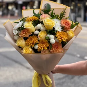 Autumn Harvest Bouquet with yellow roses, golden chrysanthemums and peach flowers in gold-edged wrapping