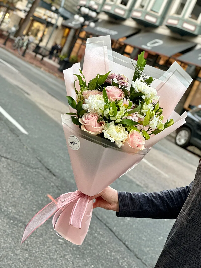 Elevate your special moments with our Blushing Beauty Bouquet, featuring pink roses and white hydrangeas. Perfect for romantic gestures or special occasions. Available for delivery in Vancouver. Order now to surprise and delight your loved one.