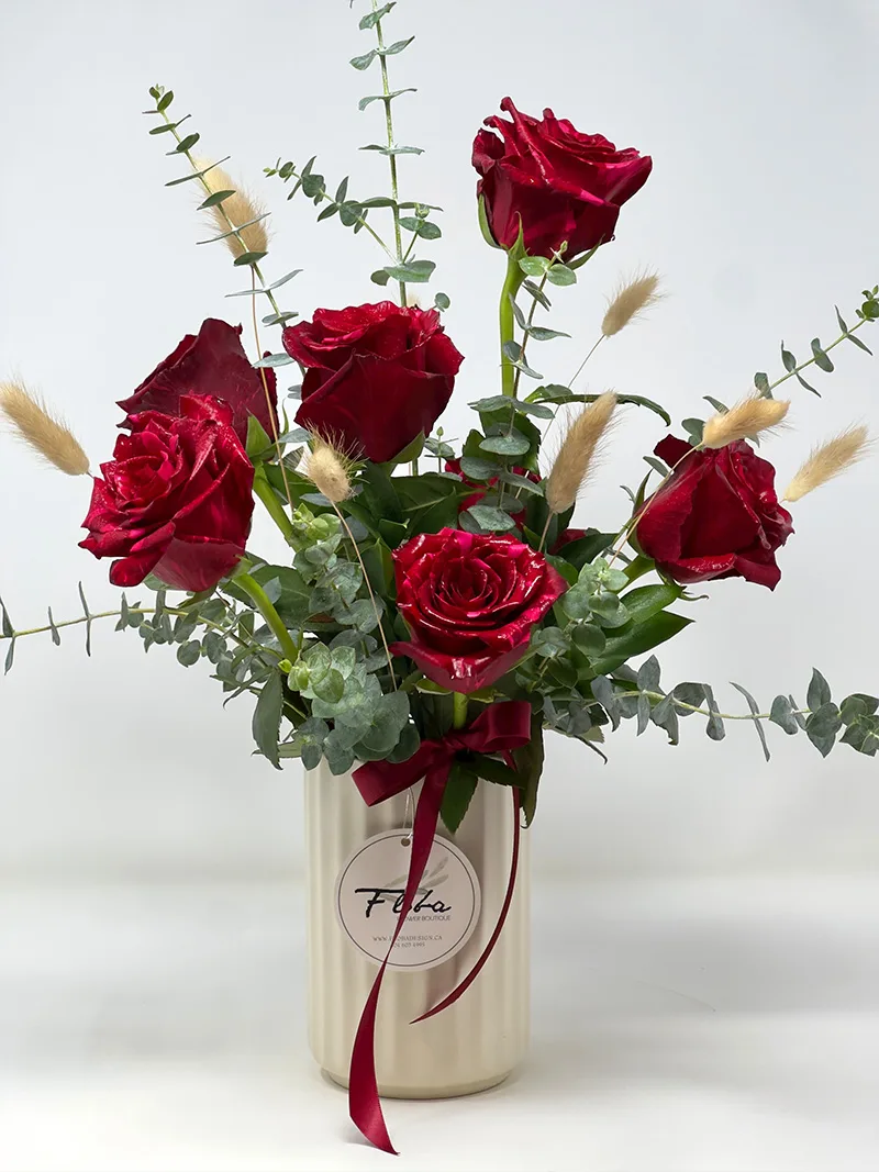 Side View - Crimson Radiance Vase Side view of Crimson Radiance Vase featuring six red roses, lush greenery, and elegant accents in a ceramic vase.