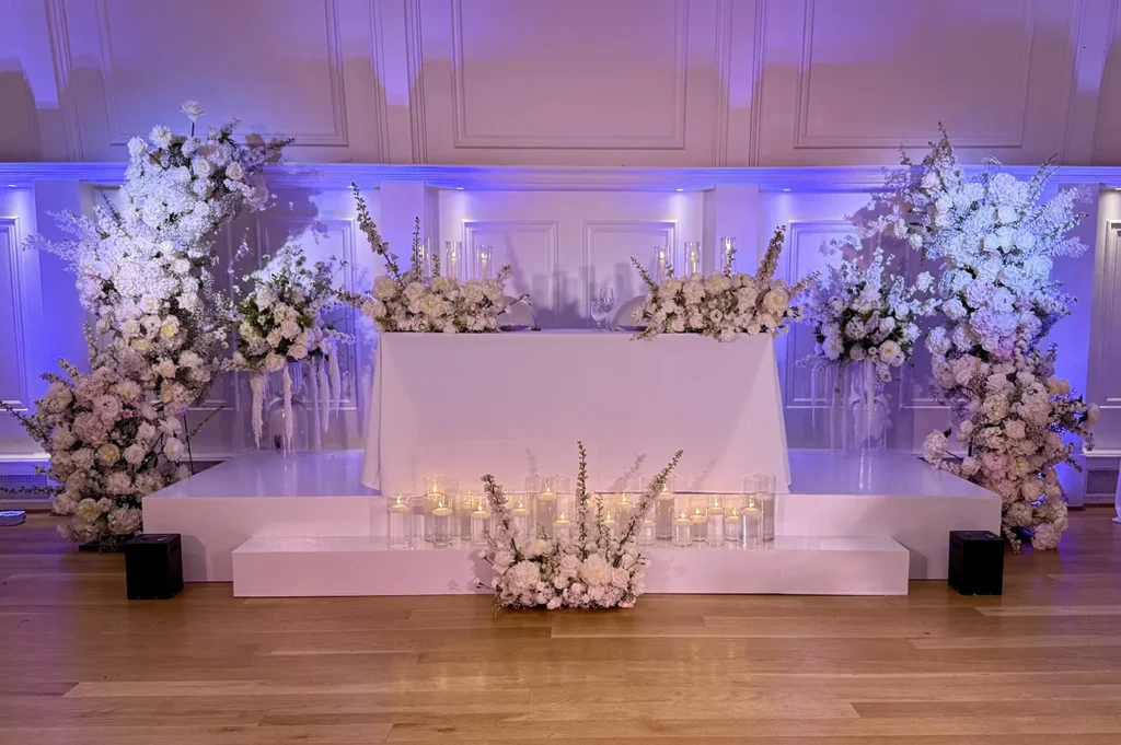 Elegant floral stage setup with purple lighting for luxury event in Vancouver