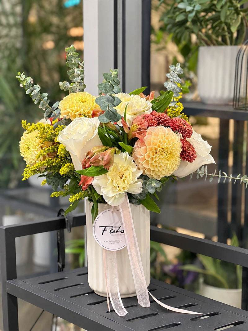 Peach Honey Flower Arrangement Front Peach & Honey flower arrangement with peach, cream and yellow blooms in a white ribbed vase